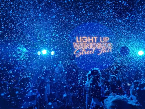 Picture of the snow flurries at Light Up Windsor, lit up blue at night