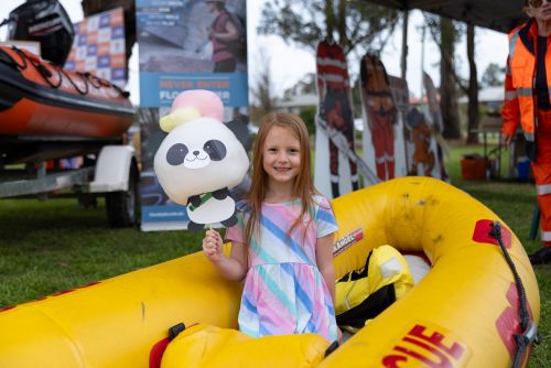 Picture of a little girl standing in a NSW SES rescue boat at Hawkesbury Fest 2024